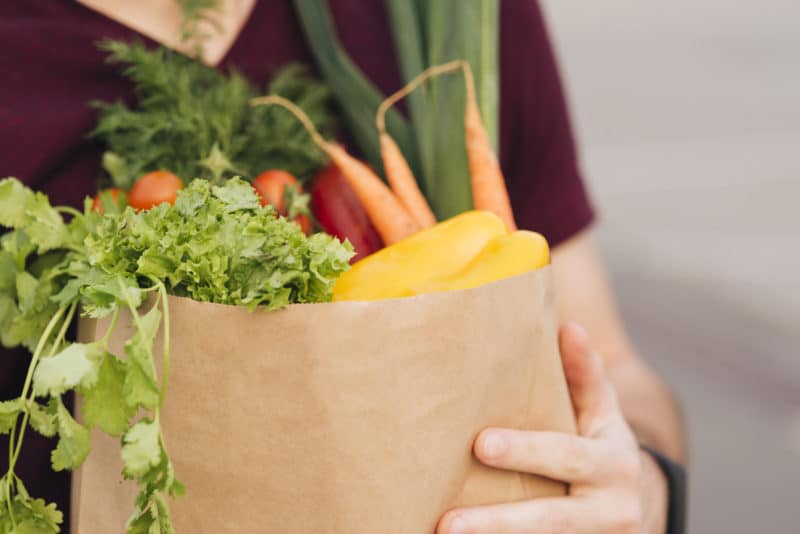 close up grocery bag with vegetables