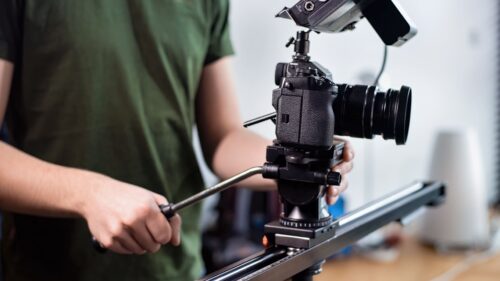 young-content-creator-man-filming-with-camera-slider-professional-rig